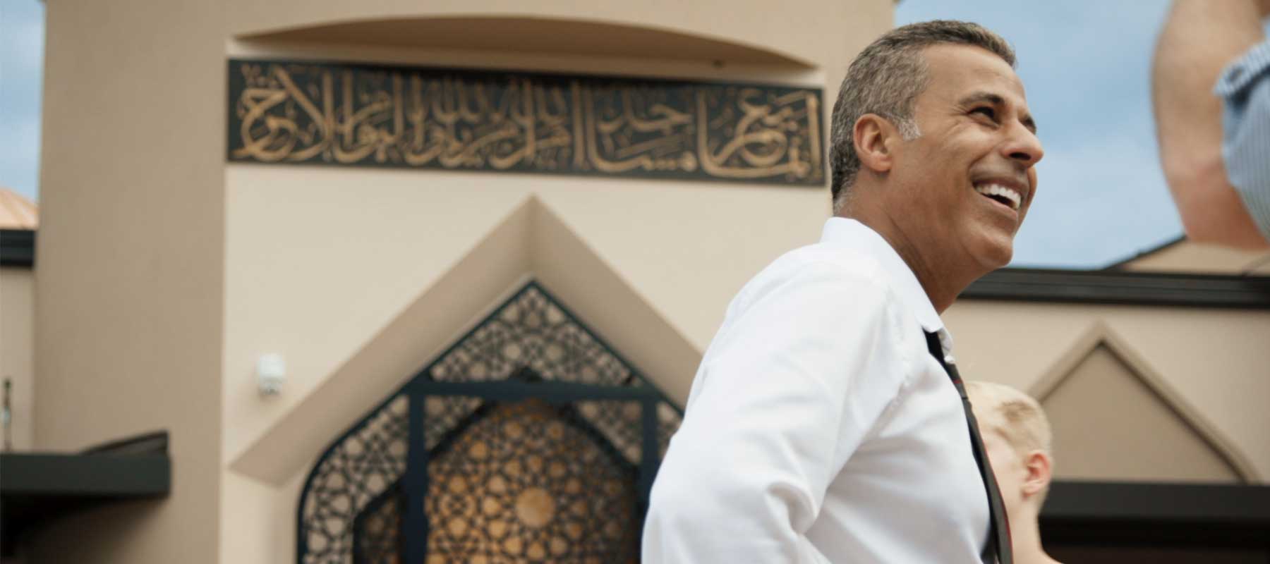 A man standing outside of a mosque.